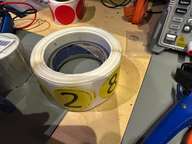 a bucket of paint sitting on a table