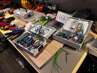 a table with a bunch of wires and a box of wires
